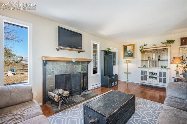 living room with a tile fireplace, dark hardwood / wood-style flooring, and a baseboard radiator