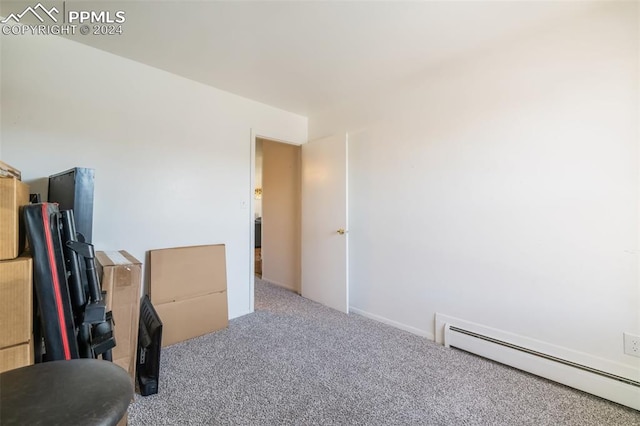 carpeted bedroom featuring a baseboard radiator