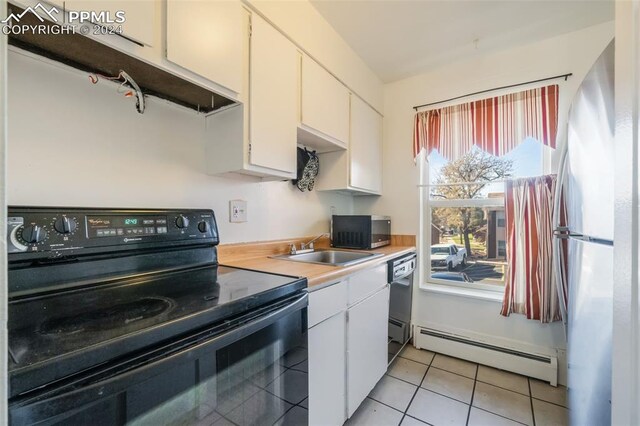 kitchen featuring light tile patterned floors, sink, white cabinetry, black appliances, and baseboard heating