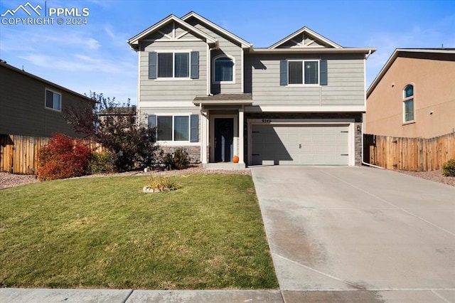 view of front of property featuring a garage and a front yard