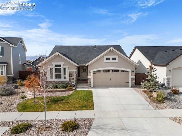 view of front of home with a garage and a front lawn