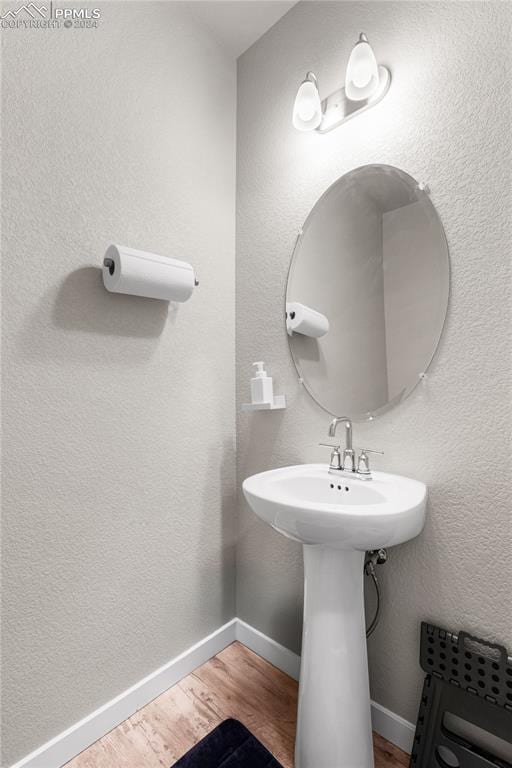 bathroom with hardwood / wood-style flooring