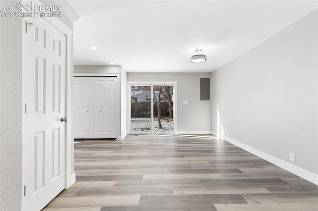 spare room with light wood-type flooring and electric panel