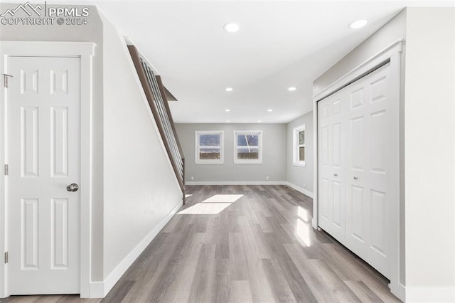 corridor with light hardwood / wood-style flooring