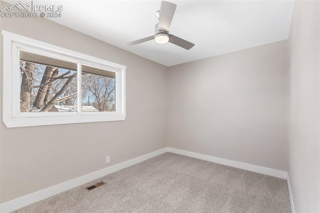 empty room with carpet floors and ceiling fan