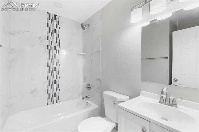 full bathroom featuring vanity, tiled shower / bath combo, and toilet