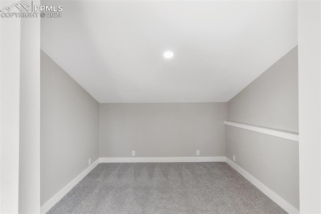 bonus room featuring carpet floors and vaulted ceiling