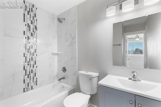 full bathroom featuring vanity, toilet, and tiled shower / bath