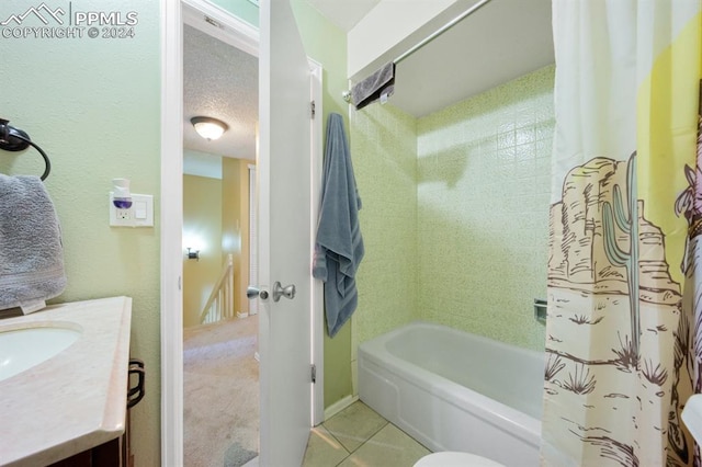 bathroom with tile patterned flooring, vanity, a textured ceiling, and shower / tub combo with curtain