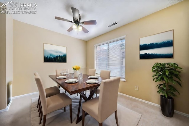 carpeted dining room featuring ceiling fan