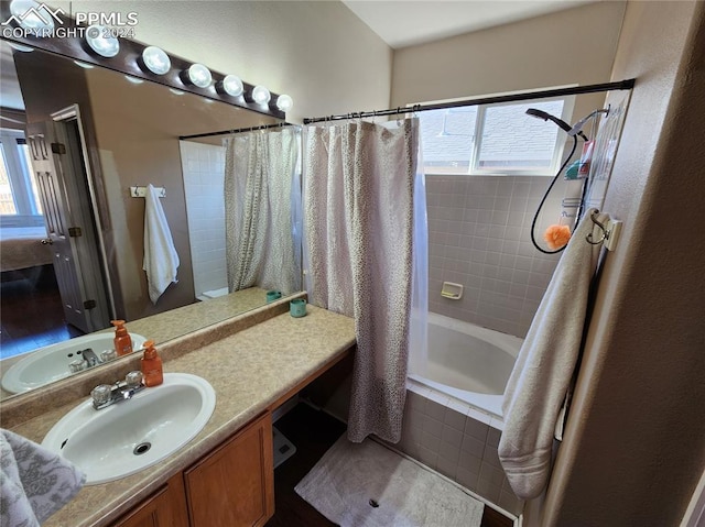 bathroom with shower / tub combo with curtain, vanity, and hardwood / wood-style floors