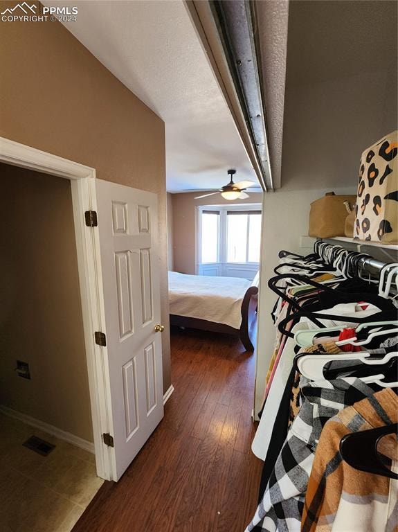 bedroom featuring dark hardwood / wood-style flooring, vaulted ceiling, and ceiling fan