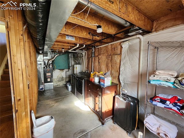 basement featuring heating unit and washer / dryer