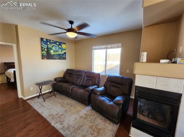 living room with a fireplace, ceiling fan, and hardwood / wood-style floors