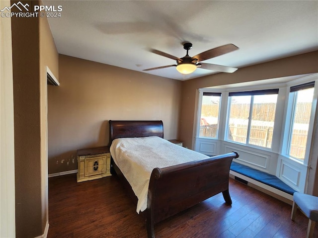 bedroom with ceiling fan and dark hardwood / wood-style flooring