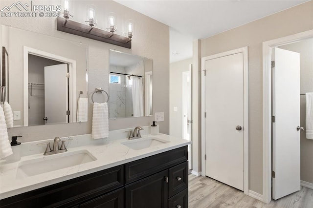 bathroom featuring hardwood / wood-style floors, vanity, and curtained shower