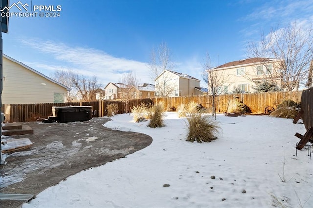 yard covered in snow with a hot tub