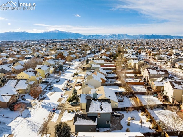 snowy aerial view with a mountain view