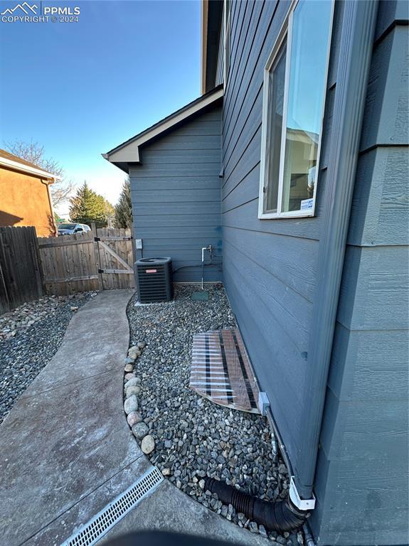 view of side of home featuring central AC unit and a patio