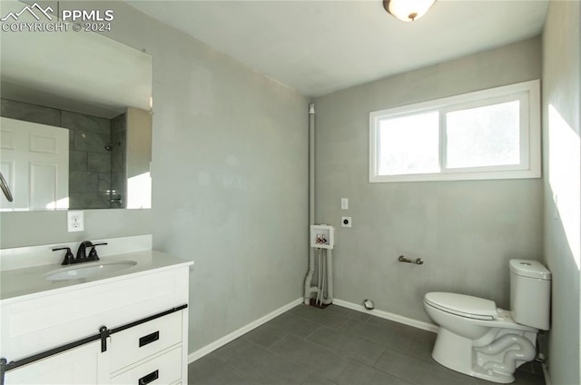 bathroom featuring tile patterned floors, vanity, and toilet