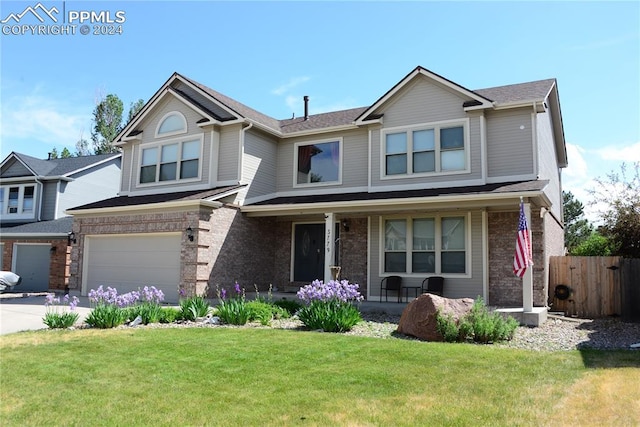 view of front facade featuring a garage and a front lawn