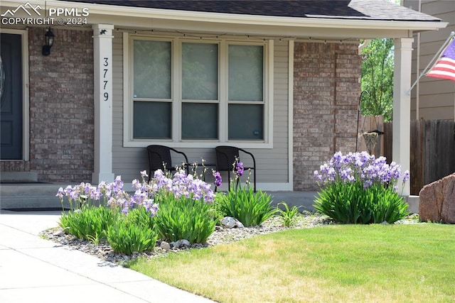 entrance to property with a lawn