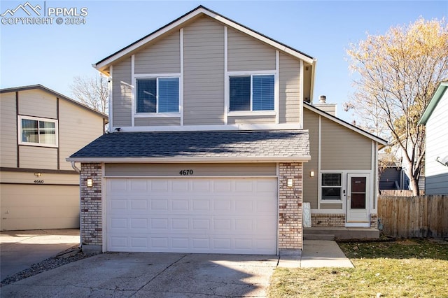 front of property with a front yard and a garage