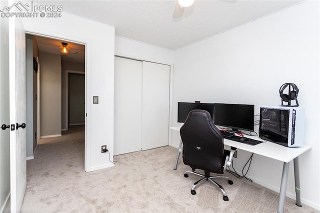 carpeted office space with ceiling fan