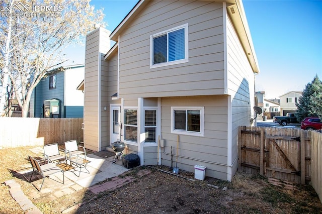 back of house with a patio