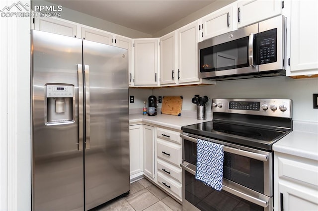 kitchen featuring light tile patterned flooring, white cabinetry, and stainless steel appliances