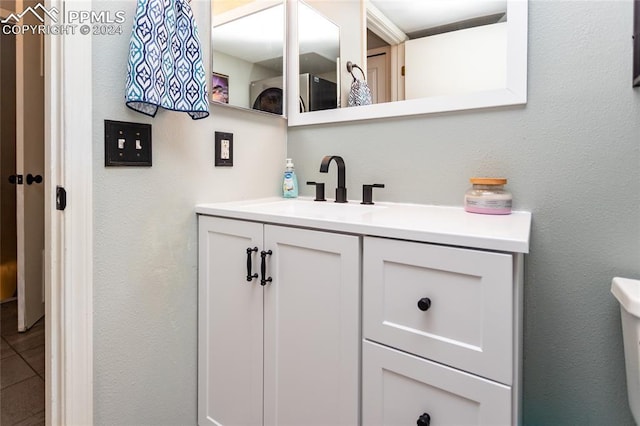 bathroom featuring vanity and toilet