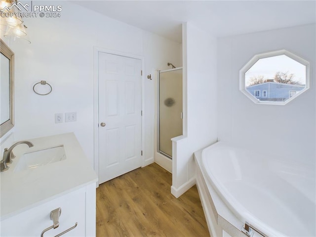 bathroom with vanity, plus walk in shower, and hardwood / wood-style flooring