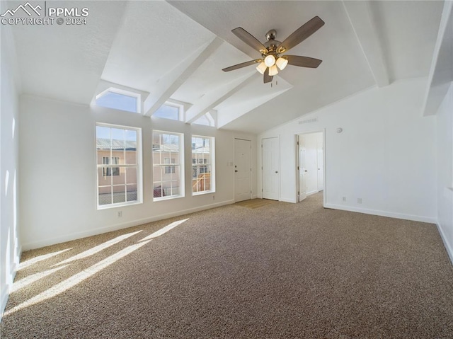 carpeted spare room featuring ceiling fan and lofted ceiling with beams