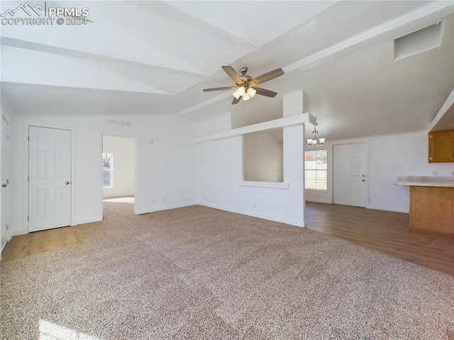 unfurnished living room featuring lofted ceiling with beams, ceiling fan with notable chandelier, and wood-type flooring