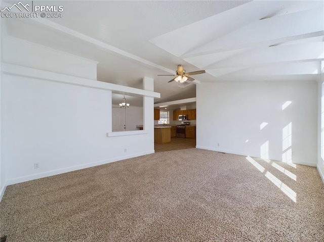 unfurnished living room featuring carpet flooring, ceiling fan with notable chandelier, vaulted ceiling, and a healthy amount of sunlight