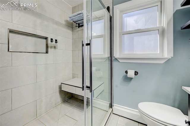 bathroom with an enclosed shower and toilet