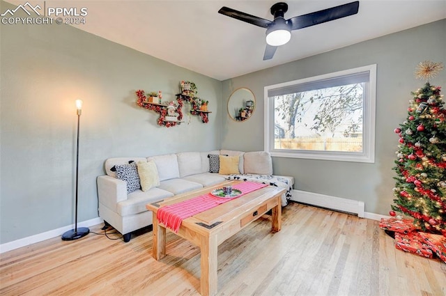 living room featuring ceiling fan and light hardwood / wood-style floors