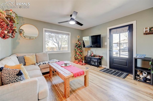 living room featuring hardwood / wood-style flooring, plenty of natural light, and ceiling fan