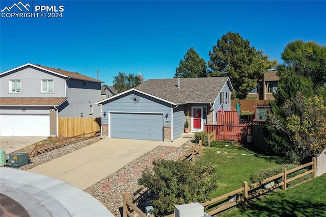 view of front of house featuring a garage and a front lawn