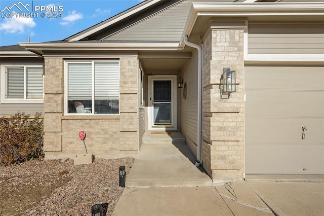 doorway to property featuring a garage