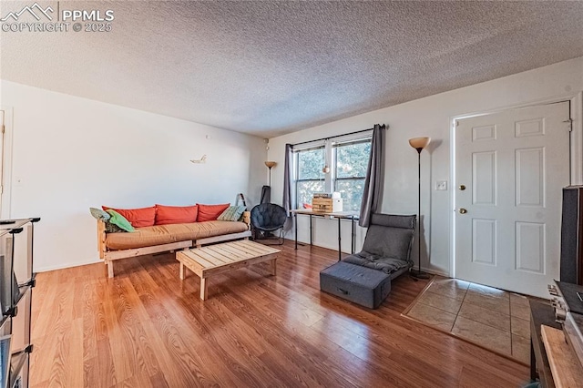 living room with hardwood / wood-style floors and a textured ceiling