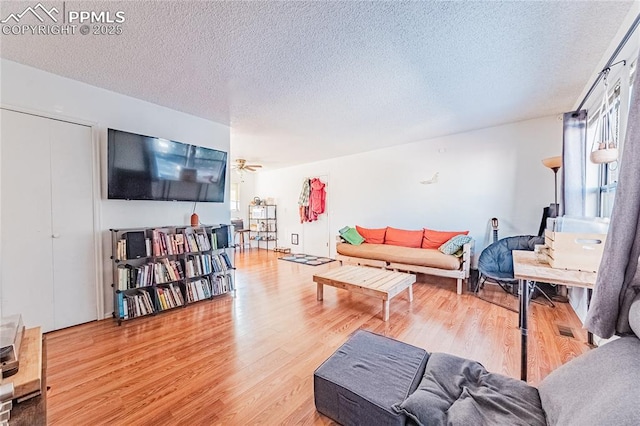 living room featuring hardwood / wood-style flooring and a textured ceiling