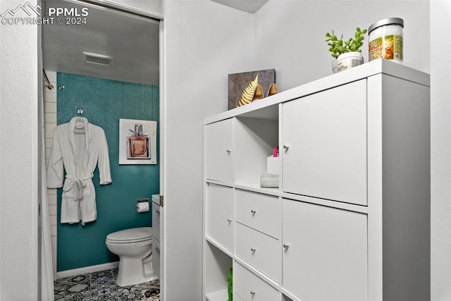 bathroom with tile patterned flooring and toilet