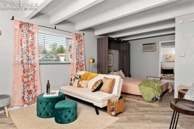 bedroom featuring beamed ceiling, a wall mounted air conditioner, and hardwood / wood-style flooring