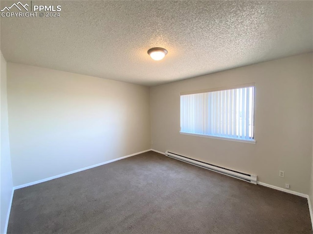 carpeted spare room with a textured ceiling and a baseboard radiator