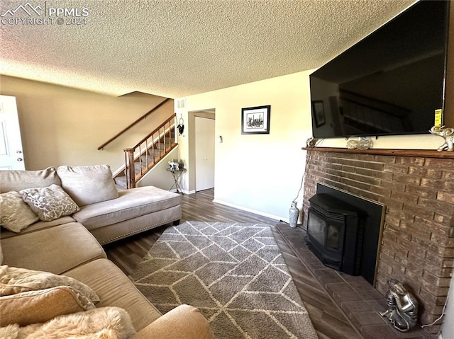 living room featuring a textured ceiling, dark hardwood / wood-style flooring, and a wood stove