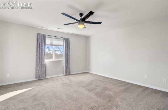 unfurnished room with ceiling fan and light colored carpet