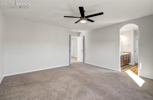 carpeted spare room with ceiling fan