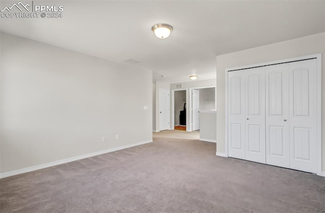 unfurnished bedroom featuring a closet and carpet