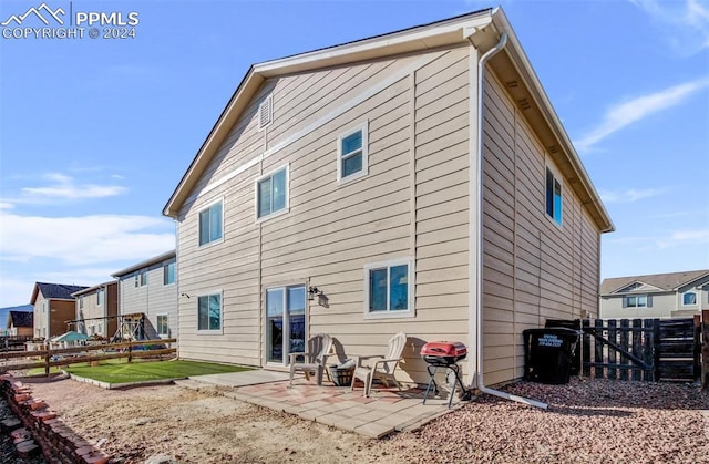 rear view of property featuring a patio